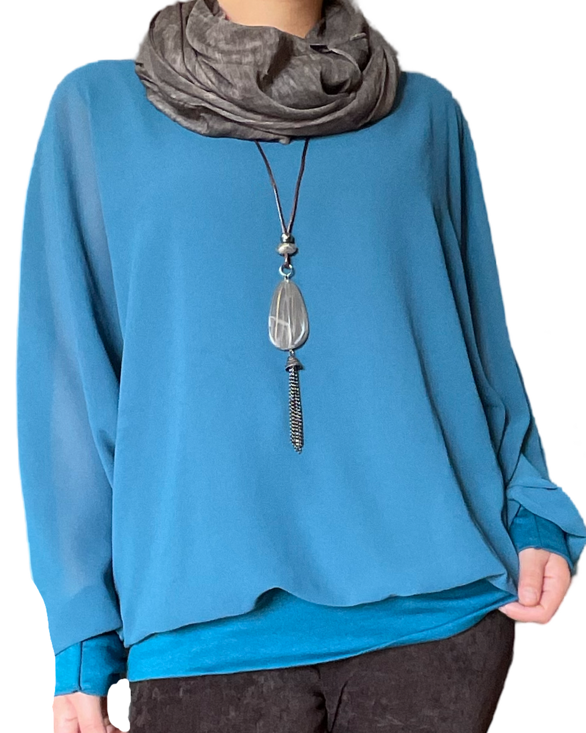 Blouse bleue à manches longues pour femme avec foulard.