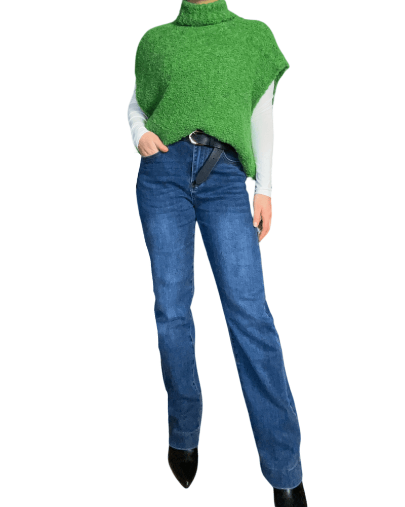 Débardeur vert à col roulé pour femme avec jeans et bottillons.