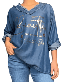 Chandail bleu jean avec franges pour femme.