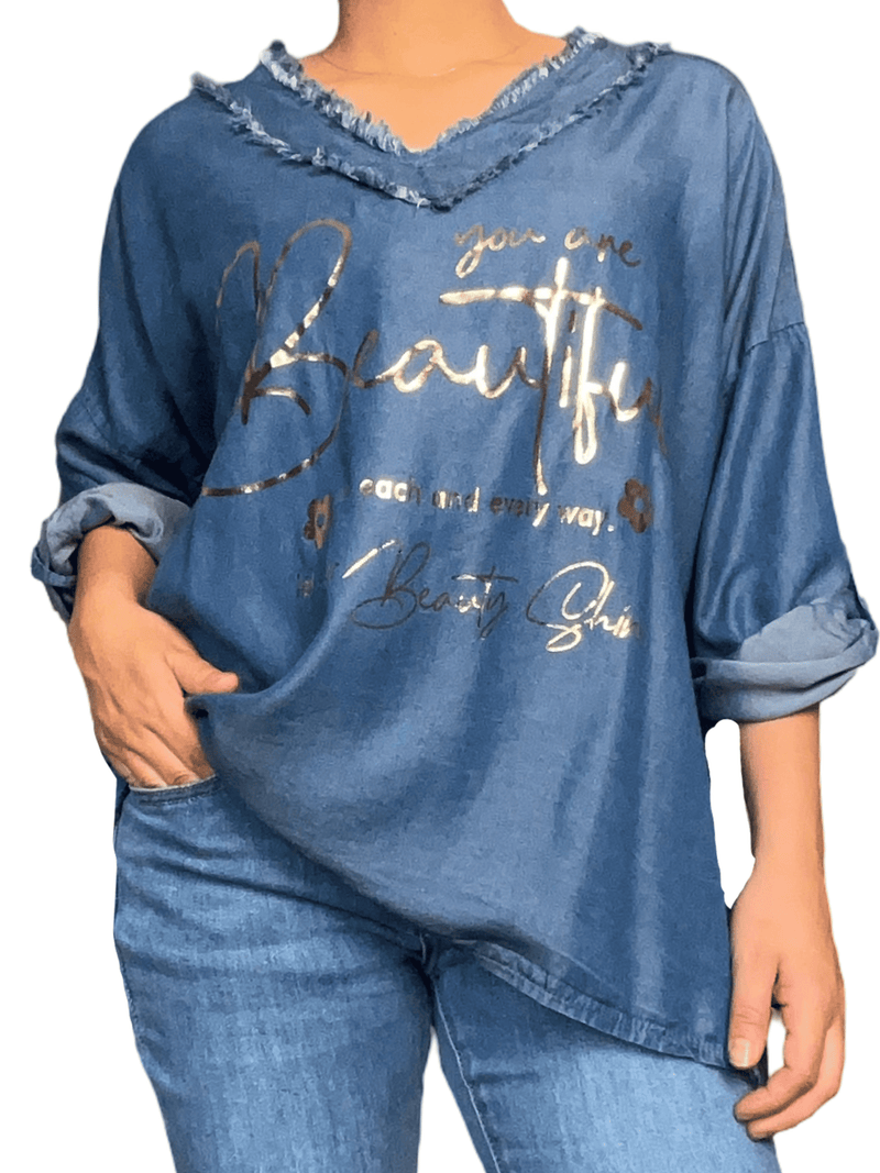 Chandail bleu jean avec franges pour femme.