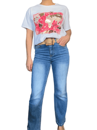 T-shirt blanc avec imprimé de carte du monde pour femme avec jeans.