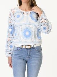 Chandail blanc en crochet à motifs de fleurs bleues