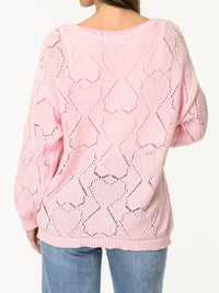 Chandail rose en tricot à motifs de cœurs