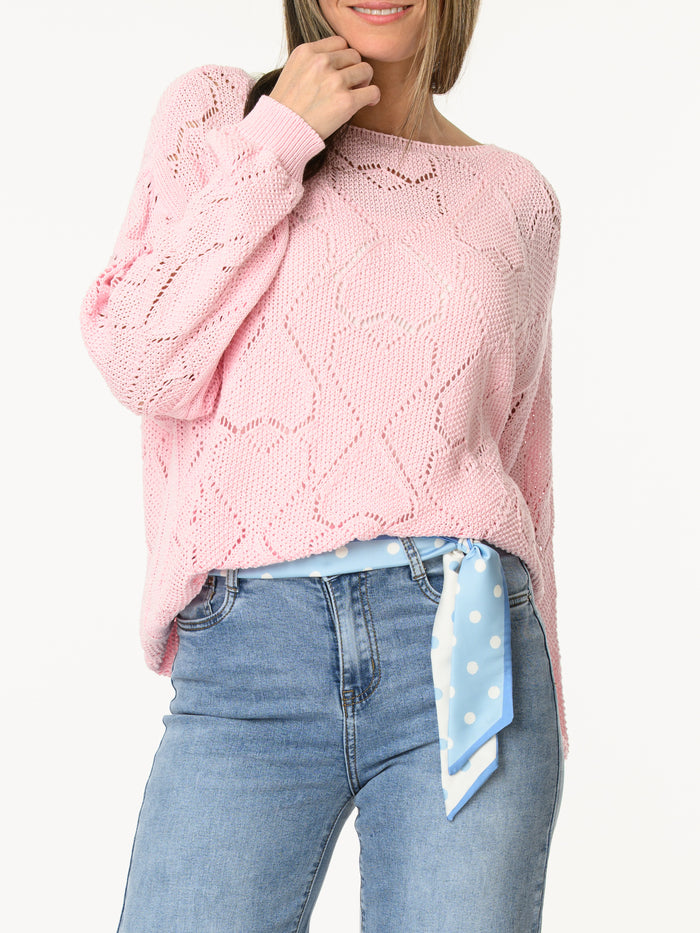 Chandail rose en tricot à motifs de cœurs