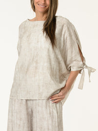 Chandail blanc et beige avec lacets sur les côtés