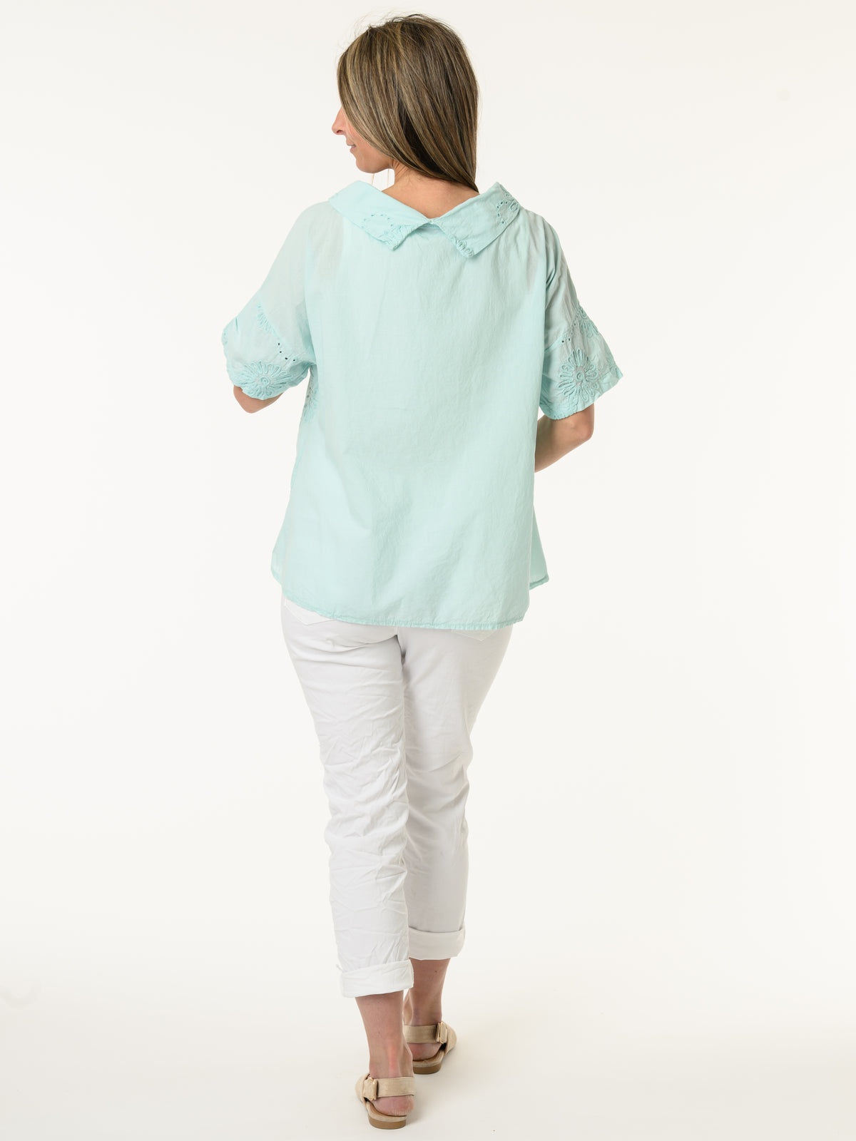 Blouse aqua à col roulé et fleurs brodées