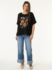 T-shirt noir avec imprimé de fleurs orange