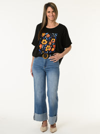 T-shirt noir avec imprimé de fleurs orange