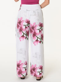 Pantalon palazzo blanc avec imprimé floral magenta