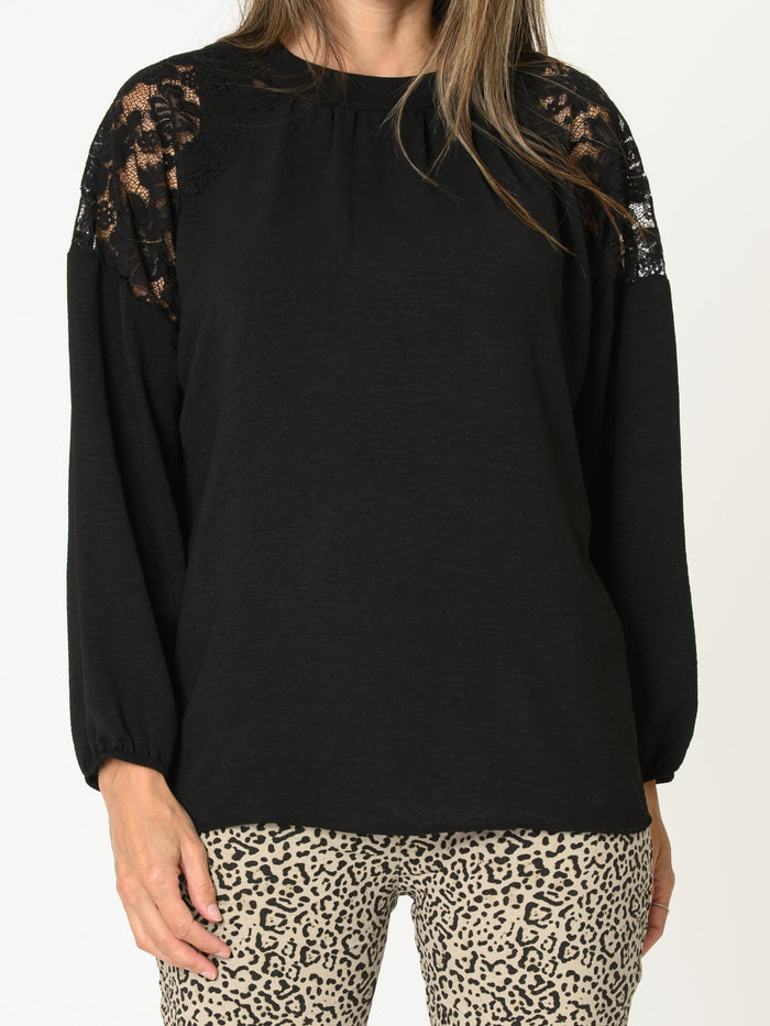 Blouse noire pour femme avec dentelle aux épaules et col montant